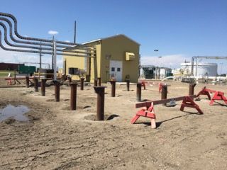 Steel piles with pile caps installed around an industrial building